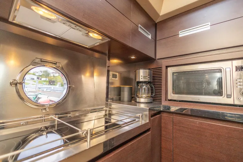  Yacht Photos Pics Luxurious kitchen interior of 2008 Azimut 62S yacht with modern appliances and porthole view.