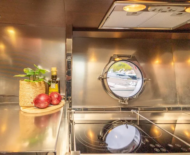  Yacht Photos Pics Luxurious 2008 Azimut 62S yacht kitchen with porthole, herbs, and cooking essentials.