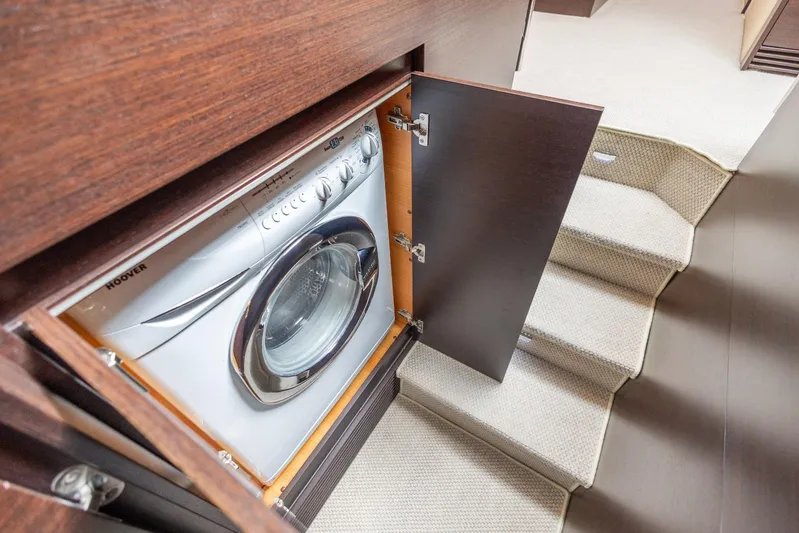  Yacht Photos Pics Built-in washing machine on 2008 Azimut 62S yacht, near carpeted stairs.