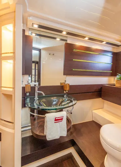  Yacht Photos Pics Luxurious bathroom interior of 2008 Azimut 62S yacht with modern glass sink and elegant wood accents.