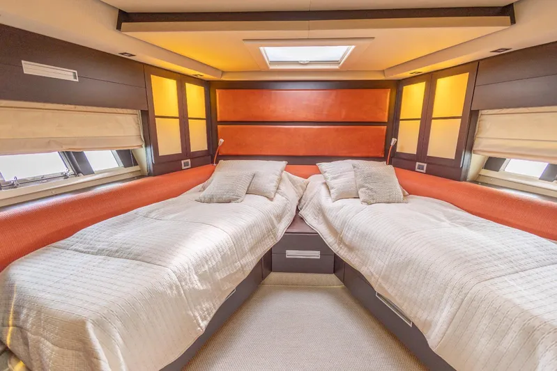  Yacht Photos Pics Luxurious twin cabin interior on a 2008 Azimut 62S yacht, featuring elegant bedding and ambient lighting.