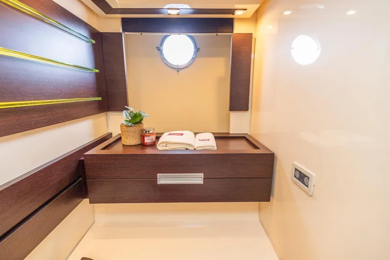  Yacht Photos Pics Luxurious bathroom interior of 2008 Azimut 62S yacht with modern wood accents and porthole.
