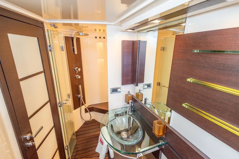  Yacht Photos Pics Luxurious bathroom interior of 2008 Azimut 62S yacht with modern fixtures and glass sink.