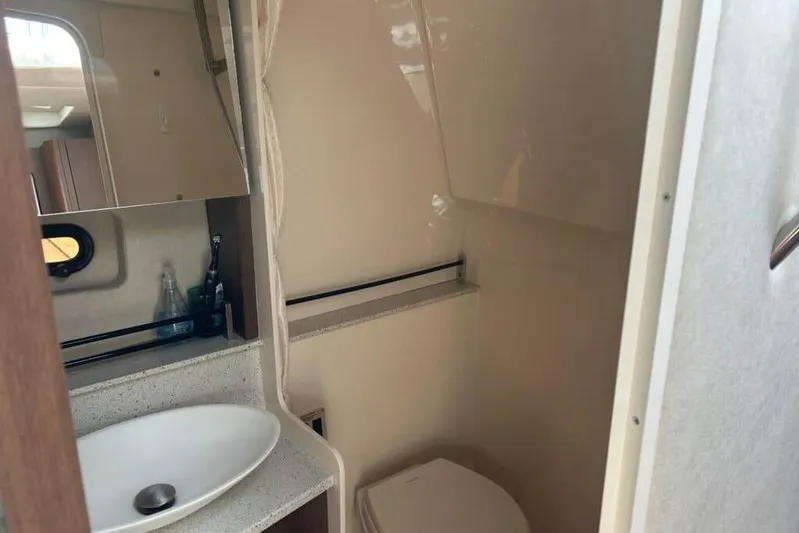  Yacht Photos Pics 2013 Searay 370 Venture bathroom with sink, mirror, and toilet.