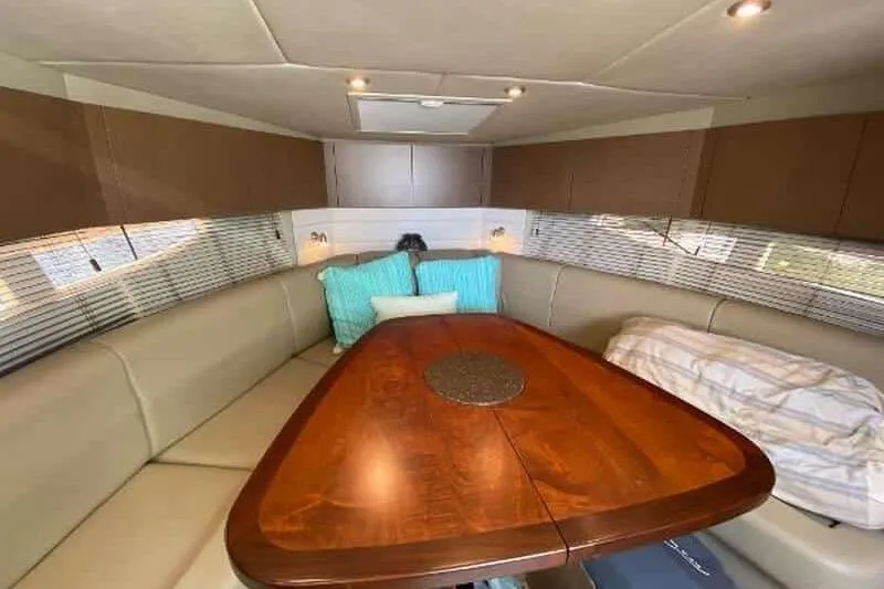 Yacht Photos Pics Interior of 2013 Searay 370 Venture boat with cozy seating and wooden table.