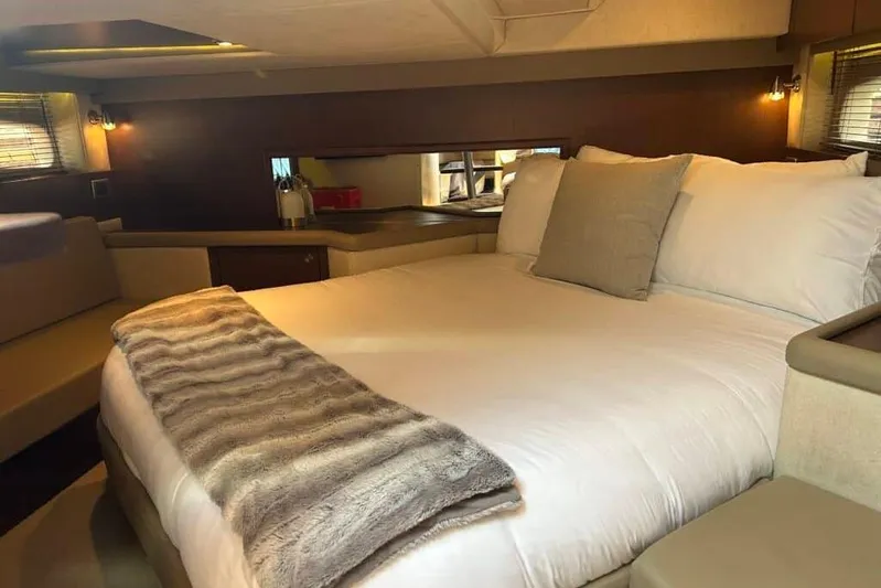  Yacht Photos Pics Luxurious cabin interior of 2013 Searay 370 Venture yacht with cozy bedding.