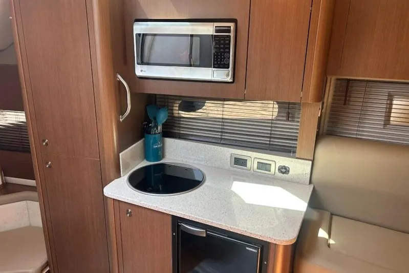  Yacht Photos Pics 2013 Searay 370 Venture yacht kitchen with microwave, stovetop, and compact fridge.