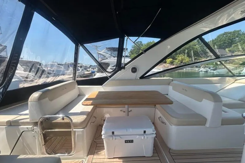  Yacht Photos Pics 2013 Searay 370 Venture boat interior with seating and table, featuring a Yeti cooler.