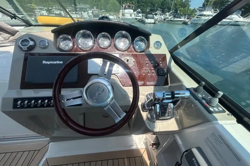  Yacht Photos Pics 2013 Searay 370 Venture helm with Raymarine electronics and wood-accented dashboard.