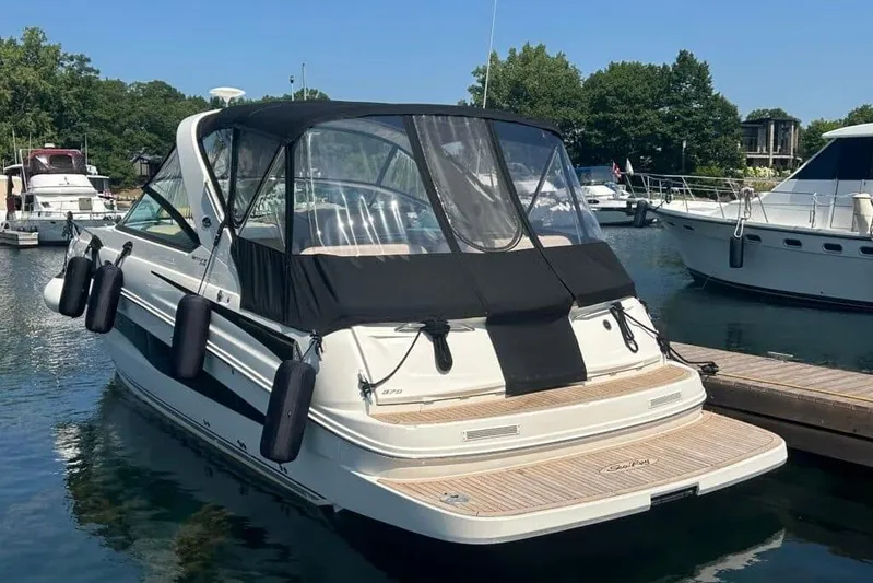  Yacht Photos Pics 2013 Searay 370 Venture boat docked in a marina, featuring a black canopy.