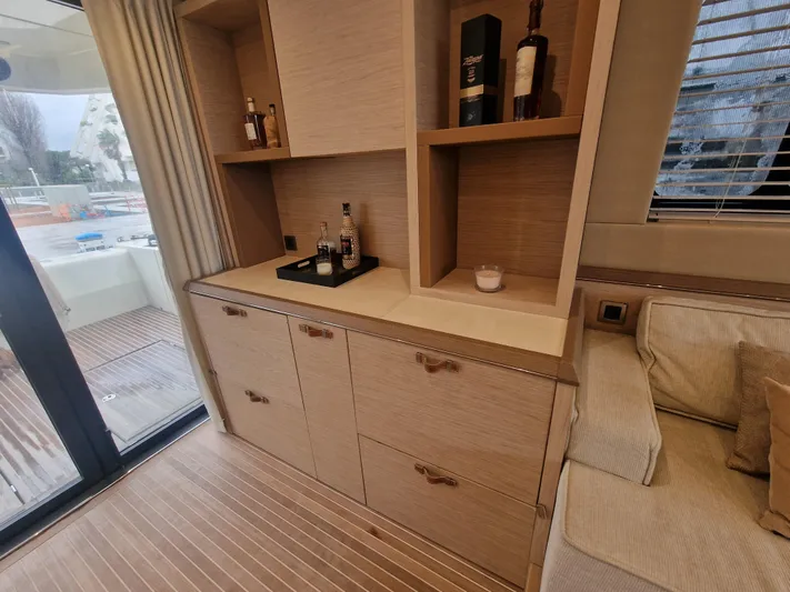 Sandrali Yacht Photos Pics Luxurious interior of 2016 Beneteau Monte Carlo 6 yacht with wooden cabinetry and seating.