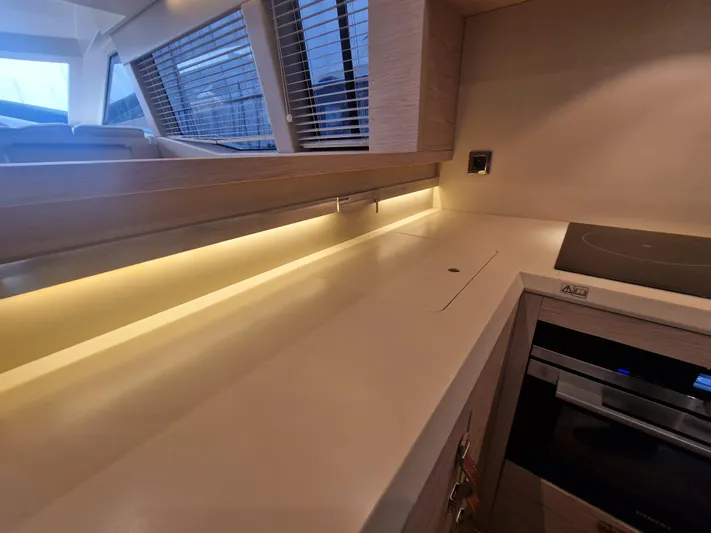 Sandrali Yacht Photos Pics Modern kitchen interior of 2016 Beneteau Monte Carlo 6 yacht with sleek countertops.