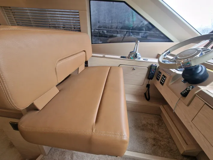 Sandrali Yacht Photos Pics Helm station of 2016 Beneteau Monte Carlo 6 with tan leather seating and modern controls.