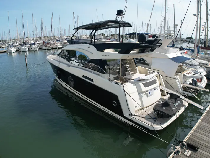 Sandrali Yacht Photos Pics 2016 Beneteau Monte Carlo 6 yacht docked in marina, surrounded by sailboats.