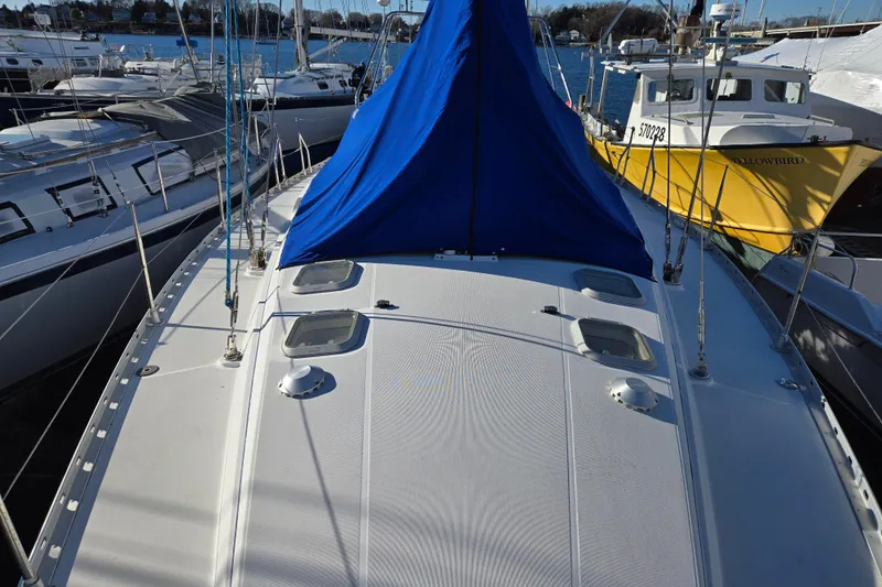 Luthien Yacht Photos Pics Jeanneau Sun Odyssey 42 Center Cockpit, 1998 model, docked at marina.