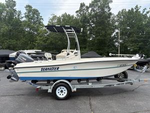 1998 Seamaster 1780 CC boat on trailer, parked outdoors with trees in background.