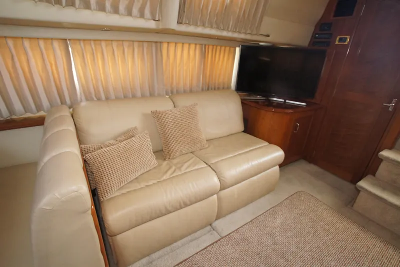 Debra Lynn Yacht Photos Pics Luxurious interior of 2005 Carver 44 Cockpit Motor Yacht with beige leather sofa.