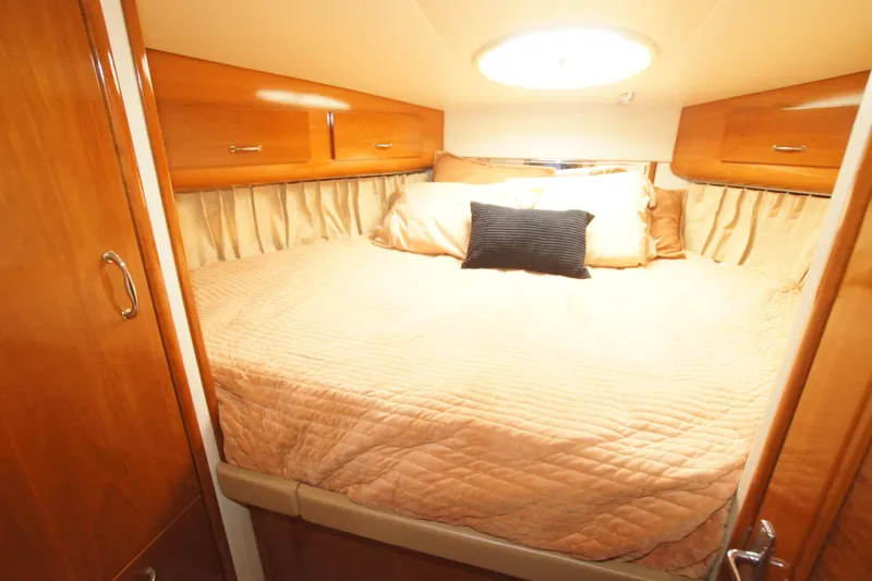 Debra Lynn Yacht Photos Pics Luxurious bedroom in 2005 Carver 44 Cockpit Motor Yacht with elegant wood finish.