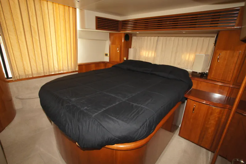 Debra Lynn Yacht Photos Pics Luxurious bedroom interior of 2005 Carver 44 Cockpit Motor Yacht with wood cabinetry.