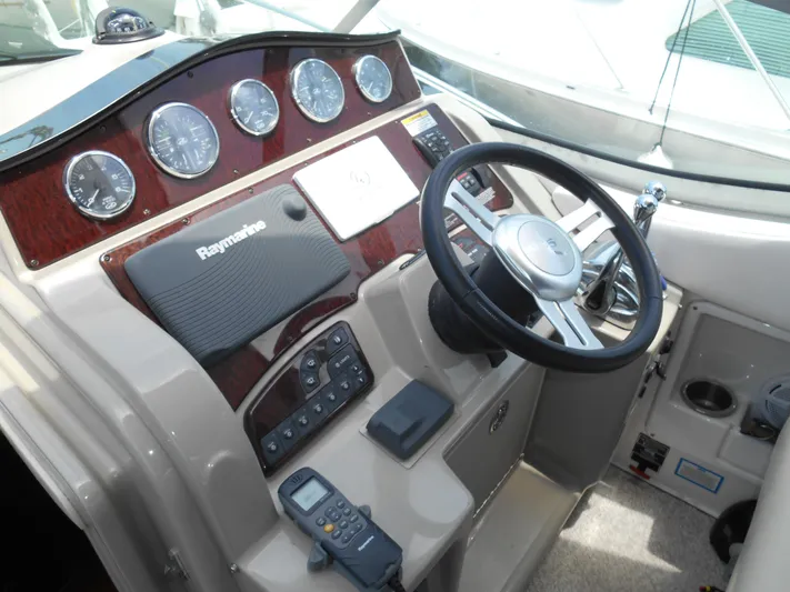 Legasea Yacht Photos Pics 2013 Sea Ray 330 Sundancer helm with steering wheel and navigation instruments.