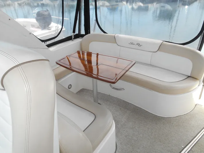 Legasea Yacht Photos Pics Interior of 2013 Sea Ray 330 Sundancer with elegant seating and wooden table.