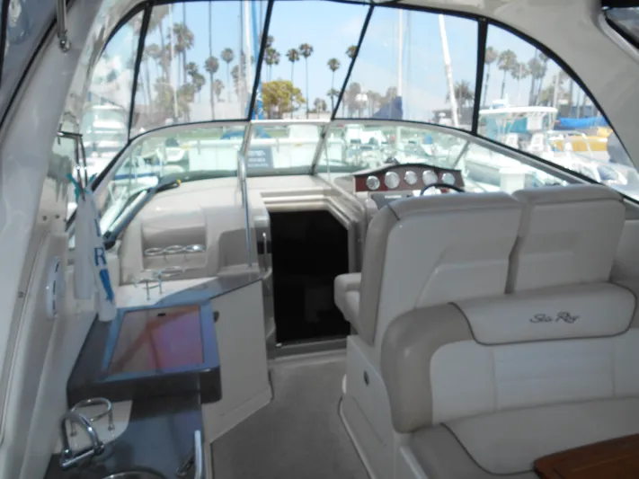 Legasea Yacht Photos Pics Interior of 2013 Sea Ray 330 Sundancer yacht with helm and seating area.