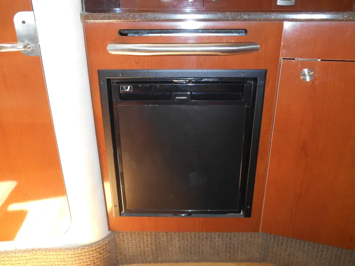 Legasea Yacht Photos Pics 2013 Sea Ray 330 Sundancer cabin refrigerator with wooden cabinetry.