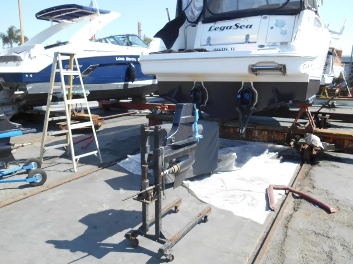 Legasea Yacht Photos Pics 2013 Sea Ray 330 Sundancer on dry dock with maintenance equipment nearby.