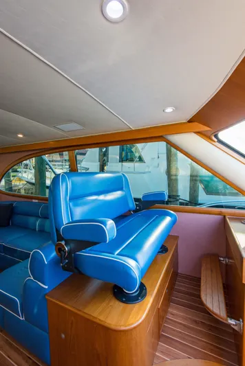 Oyster Yacht Photos Pics 2012 Custom Carolina Ritchie Howell 60 Sportfish interior with blue seating and wooden accents.