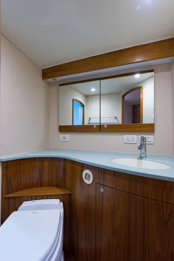Oyster Yacht Photos Pics 2012 Custom Carolina Ritchie Howell 60 Sportfish bathroom with modern fixtures and wooden cabinetry.