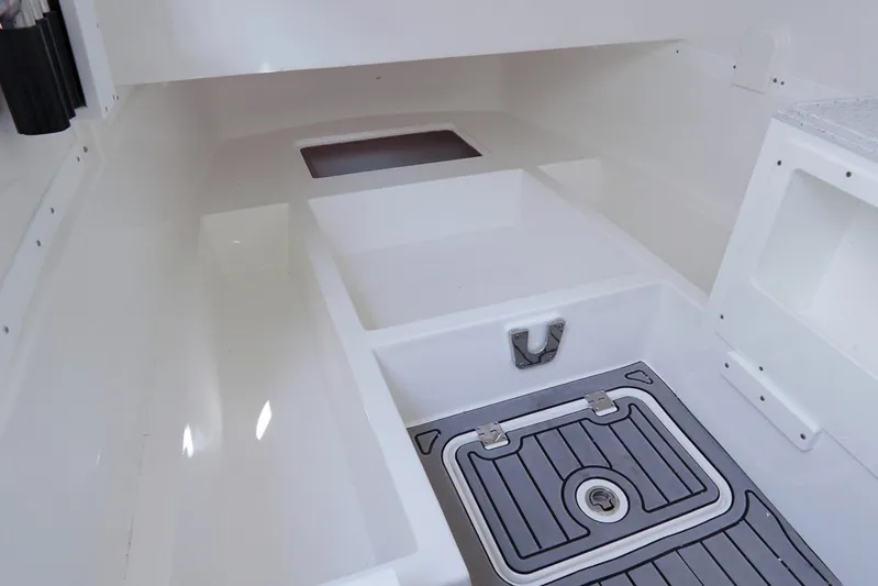  Yacht Photos Pics 2023 Tidewater 380 CC Adventure boat interior with storage compartments and non-slip flooring.