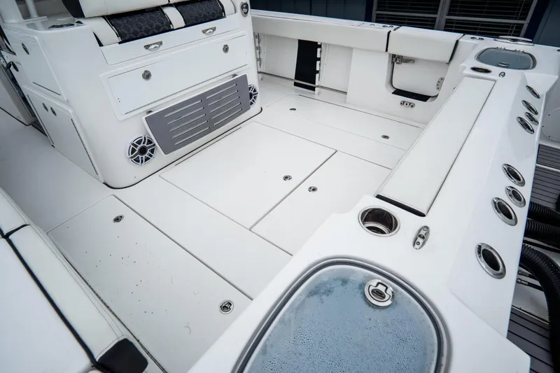  Yacht Photos Pics 2023 Tidewater 380 CC Adventure boat deck with seating and storage compartments.