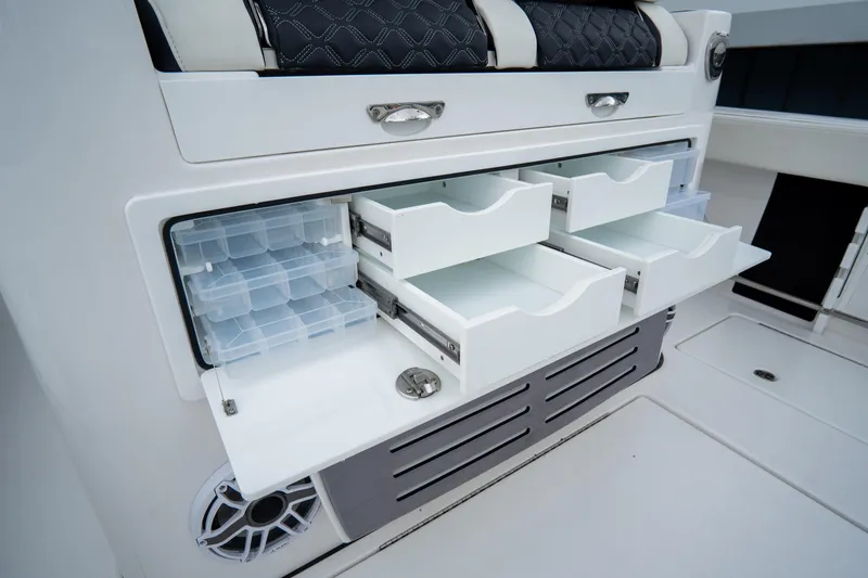  Yacht Photos Pics Tidewater 380 CC Adventure 2023 boat storage drawers with tackle boxes and seating.