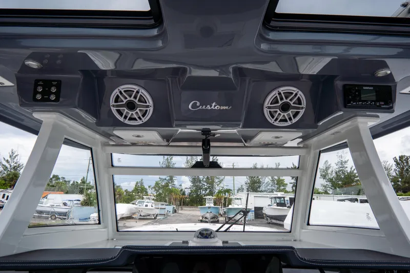  Yacht Photos Pics Interior view of 2023 Tidewater 380 CC Adventure boat with speakers and control panel.