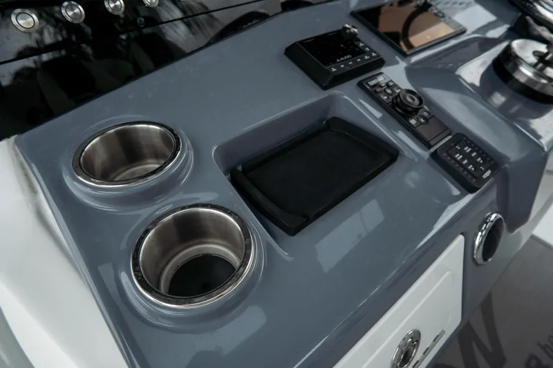  Yacht Photos Pics Control panel of 2023 Tidewater 380 CC Adventure boat with cup holders and navigation controls.
