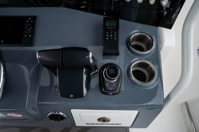  Yacht Photos Pics 2023 Tidewater 380 CC Adventure boat console with controls and cup holders.