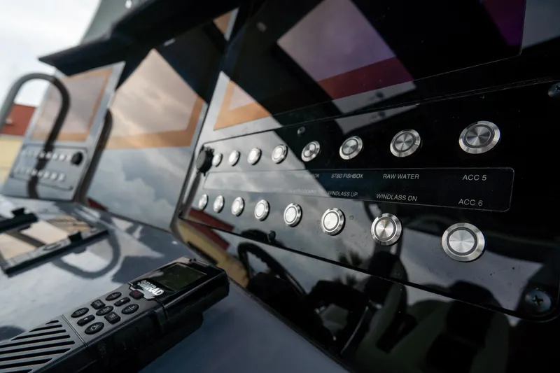  Yacht Photos Pics Control panel of 2023 Tidewater 380 CC Adventure boat with buttons and radio.
