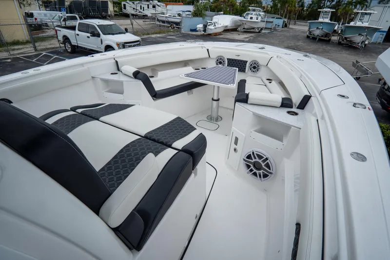  Yacht Photos Pics 2023 Tidewater 380 CC Adventure boat interior with seating and table.