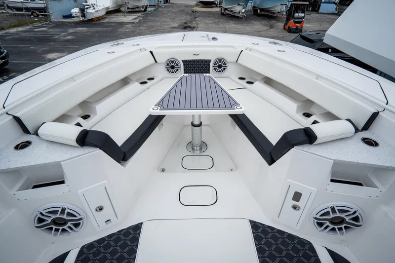  Yacht Photos Pics 2023 Tidewater 380 CC Adventure boat interior with seating and table.