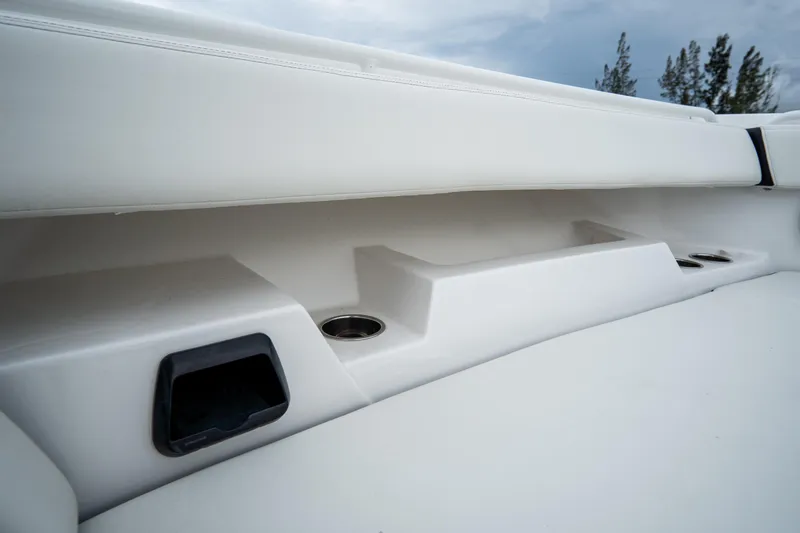  Yacht Photos Pics 2023 Tidewater 380 CC Adventure boat interior with cup holders and storage compartments.