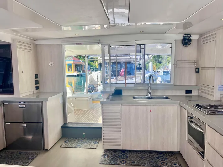 Ida Cat Yacht Photos Pics Modern kitchen interior of 2017 Leopard 51 Powercat yacht with sleek design and ample natural light.
