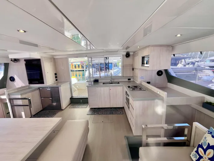 Ida Cat Yacht Photos Pics Spacious interior of 2017 Leopard 51 Powercat yacht with modern kitchen and dining area.