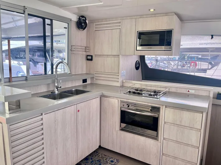 Ida Cat Yacht Photos Pics Modern kitchen interior of 2017 Leopard 51 Powercat yacht with sleek appliances and ample counter space.