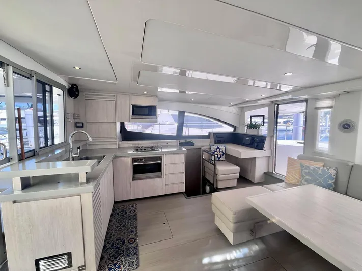 Ida Cat Yacht Photos Pics Luxurious interior of 2017 Leopard 51 Powercat yacht with modern kitchen and seating area.