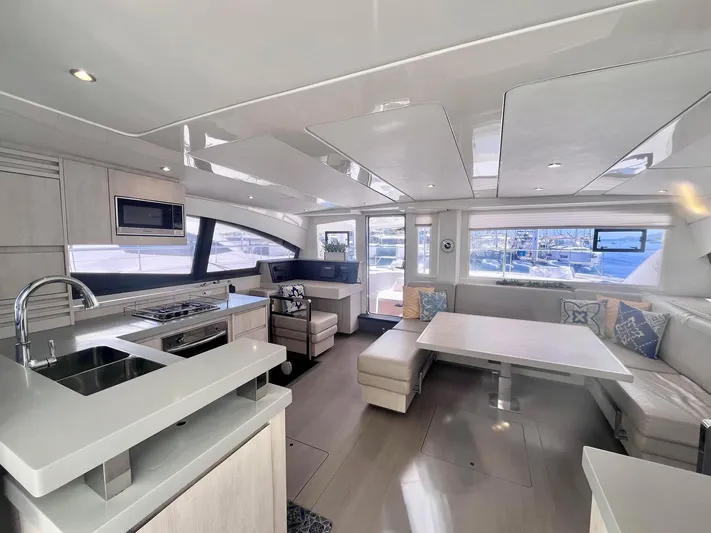 Ida Cat Yacht Photos Pics Luxurious interior of 2017 Leopard 51 Powercat yacht with modern kitchen and seating area.