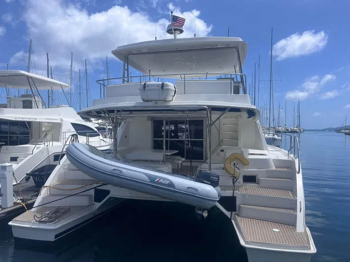 Ida Cat Yacht Photos Pics 2017 Leopard 51 Powercat yacht docked with inflatable boat, clear sky, and marina background.
