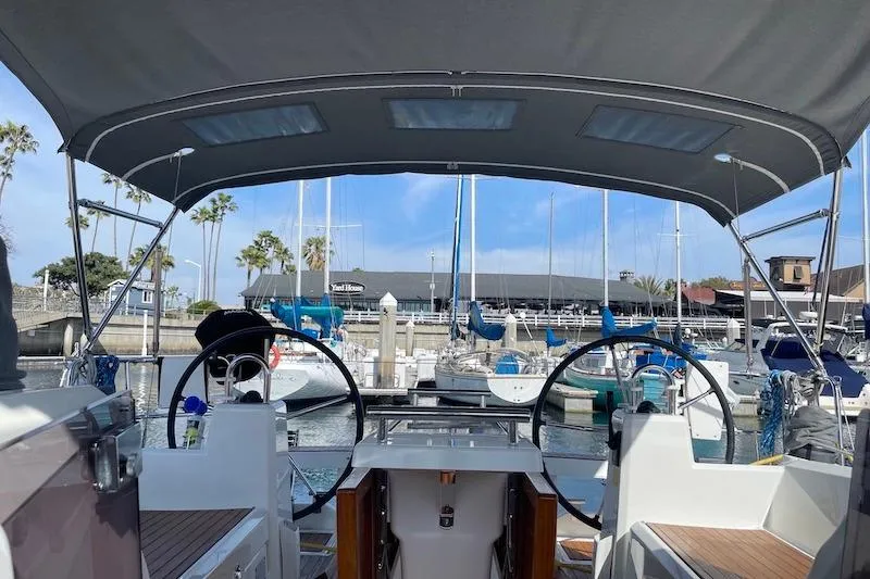 Dulce Vida Yacht Photos Pics 2022 Beneteau Oceanis 35.1 sailboat cockpit view in marina setting.