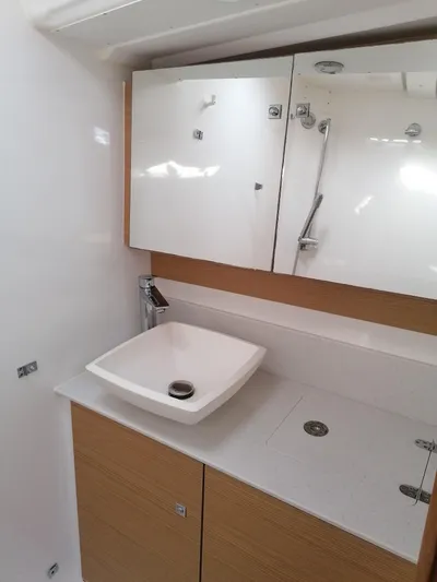  Yacht Photos Pics Modern bathroom in 2019 Dufour 460 Grand Large yacht with sleek sink and mirrored cabinet.