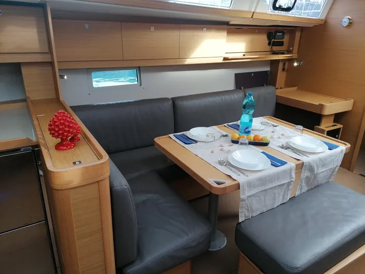  Yacht Photos Pics Interior of 2019 Dufour 460 Grand Large yacht with dining setup and modern furnishings.