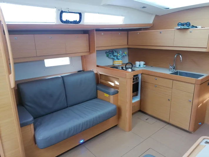  Yacht Photos Pics Modern interior of 2019 Dufour 460 Grand Large yacht with sleek kitchen and seating area.